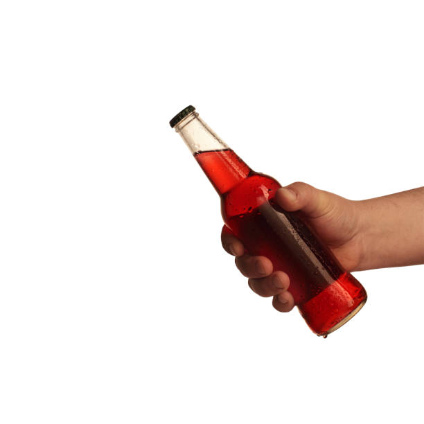 istock a bottle of beer kept in hand on a white background 1161423138