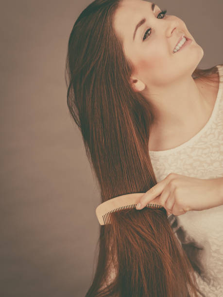 istock Happy woman brushing her hair 1161423266