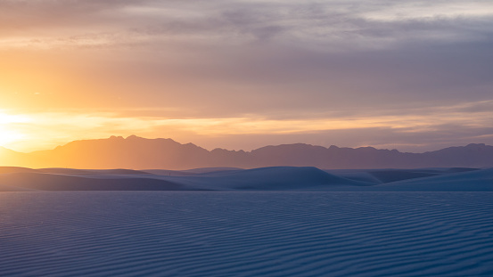 Sunset at White Sands National Monument with mountains in the background