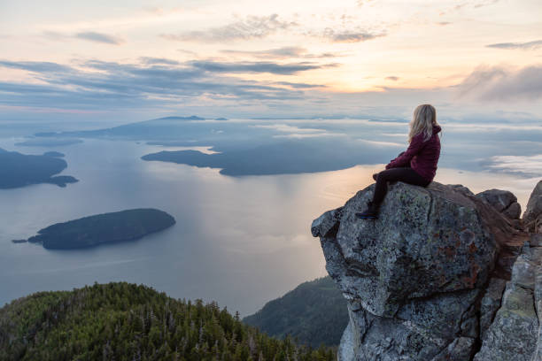 istock Adventurous Hiker on top of a Mountain during Sunset 1161425599