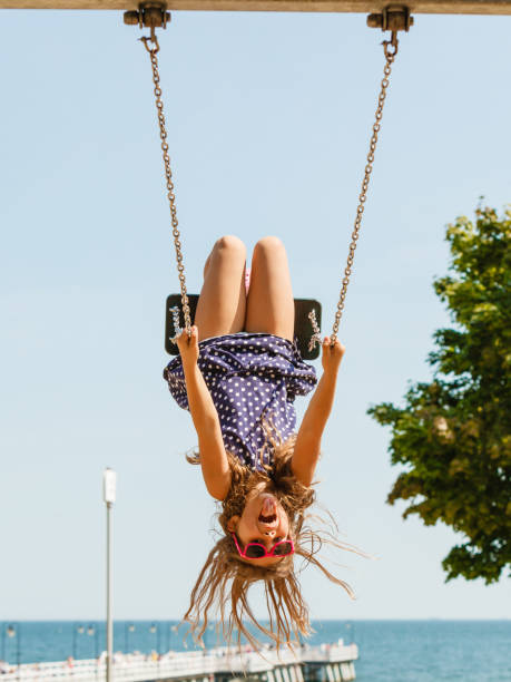 istock Playful crazy girl on swing. 1161427964