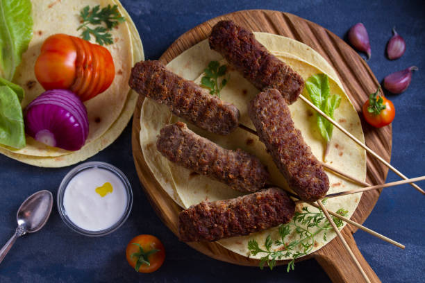 istock Kofta kebabs on skewers with pita bread,  vegetables and yogurt sauce 1161429064