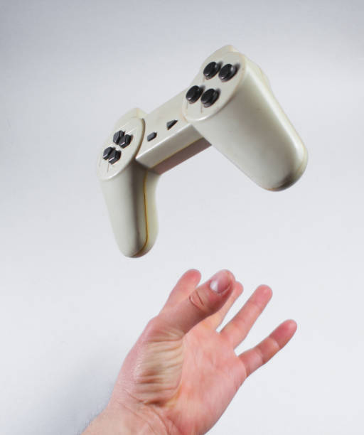istock Male hand throwing up a gamepad on a gray background. 1161429201