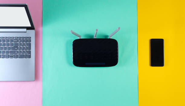 istock Wi fi router, smartphone, laptop on colored background. Top view 1161429309