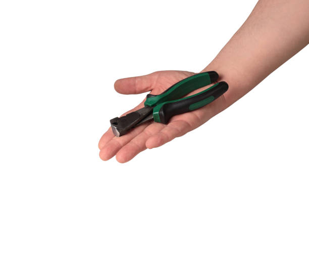 istock pincers in a hand on a white background 1161429382