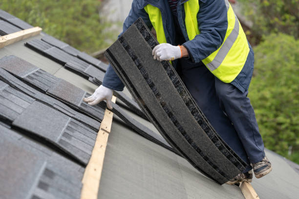 istock Professional roofer worker in uniform work wear installing asphalt or bitumen shingle on top of the new roof under construction residential building 1161429600