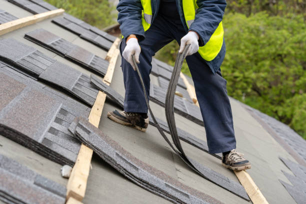 istock Mature and unrecognizable collar worker or roofer in uniform work wear installing asphalt or bitumen shingle on top of the new roof under construction residential building 1161429624