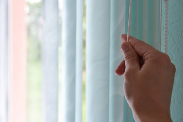 istock Male hand opens and closes the bright curtains 1161429669