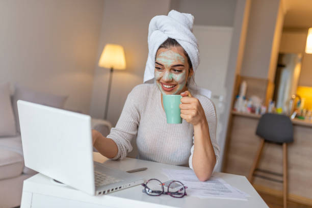 istock Girl is working from home, she has face mask and she is in the bath robe. 1161432342