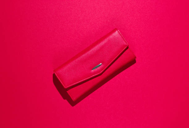 istock Fashionable leather wallet on red background. Top view 1161432404