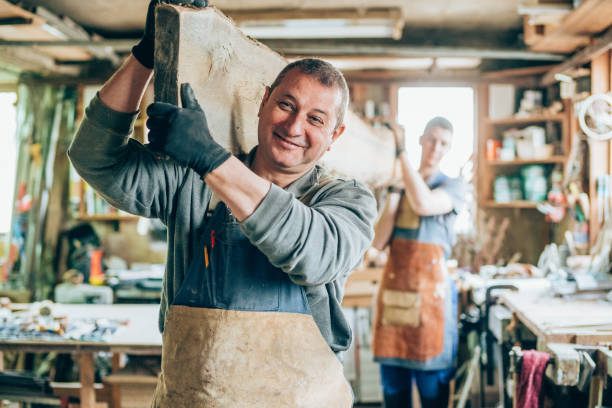 istock Carpenters carrying a wood plank 1161433382