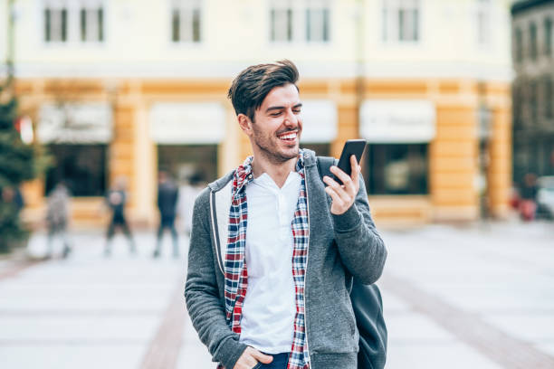 istock Young man with smart phone in the city 1161433466