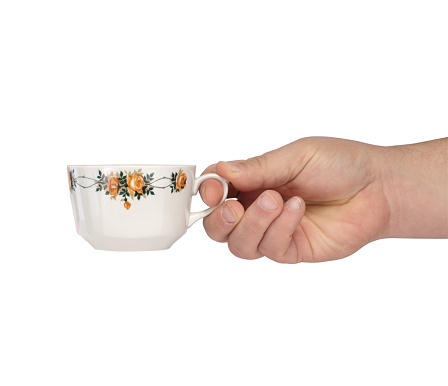 white cup in a hand on a white background