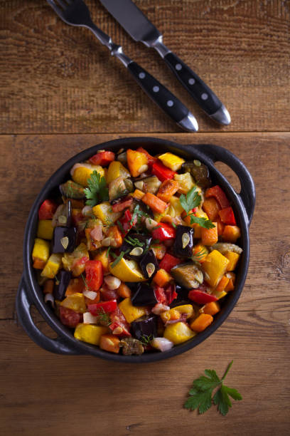 istock Vegetable stew: aubergines, paprika pepper, tomatoes, zucchini, carrots and onions. Stewed vegetable salad 1161434708