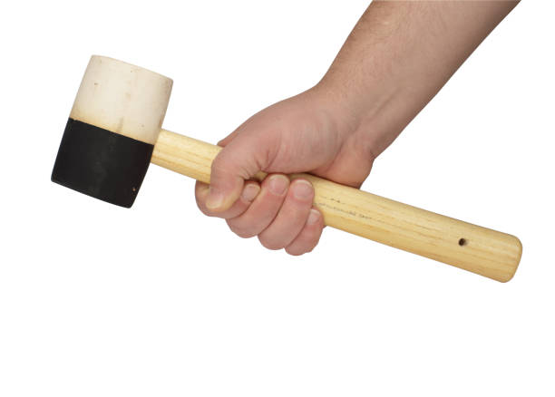istock rubber hammer in a hand on a white background 1161436140