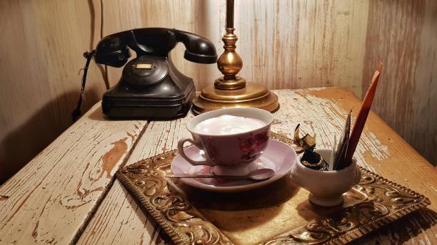 istock Coffee and a black old telephone with a vintage aspect 1161440870