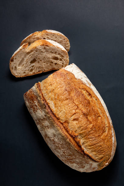 istock Fresh sliced ​​bread on a black background. View from above 1161443140
