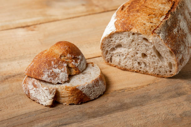 istock Fresh bread slices on a wooden table. View from above 1161443363