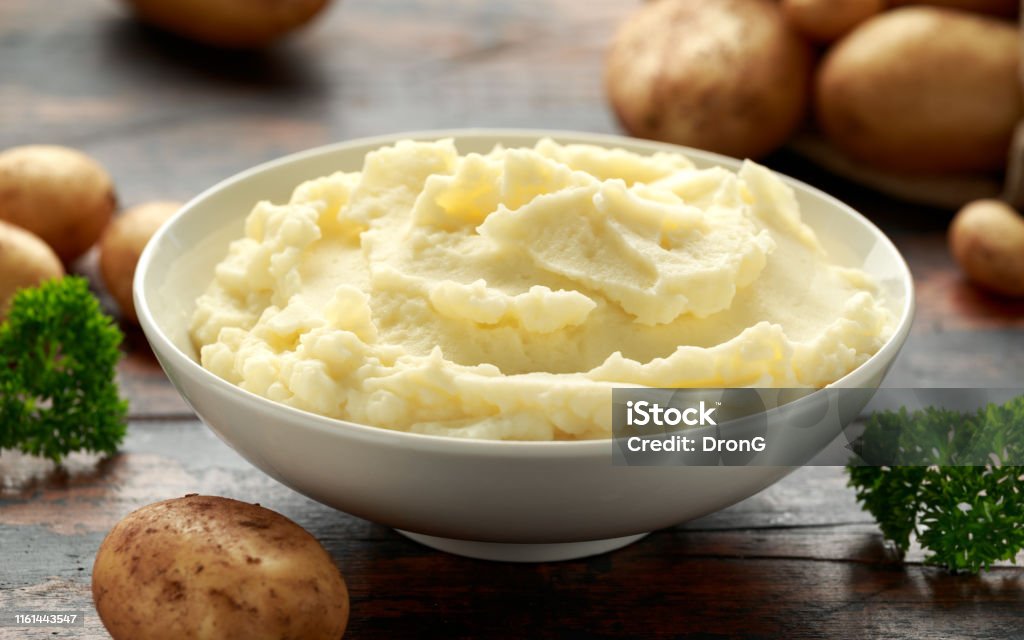 Mashed potatoes in white bowl on wooden rustic table. Healthy food Mashed potatoes in white bowl on wooden rustic table. Healthy food. Mashed Potatoes Stock Photo