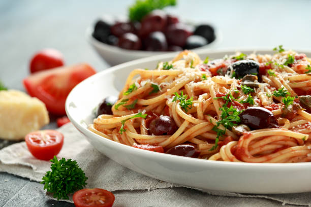 istock Pasta Alla Puttanesca with garlic, olives, capers, tomato and anchois fish 1161443608