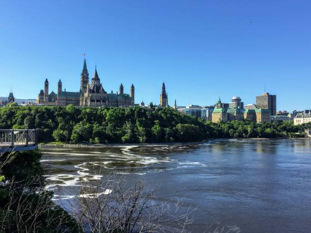 A view from the Alexandra Bridge on a beautiful sunny summer day of Parliament hill, the Supreme Court of Canada and the Ottawa River in Ottawa, Ontario, Canada A view from the Alexandra Bridge on a beautiful sunny summer day of Parliament hill, the Supreme Court of Canada and the Ottawa River in Ottawa, Ontario, Canada chateau laurier stock pictures, royalty-free photos & images