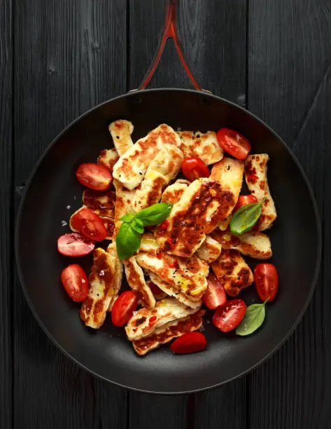 Pan-seared halloumi cheese and sweet cherry tomatoes salad.