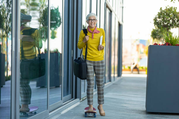 istock Senior Businesswoman Standing On Skateboard 1161448048