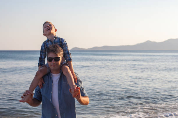 istock Father holding son on his shoulders at the beach 1161449043