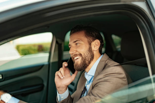 istock Businessman Talking on the Phone while Driving a Car 1161450620