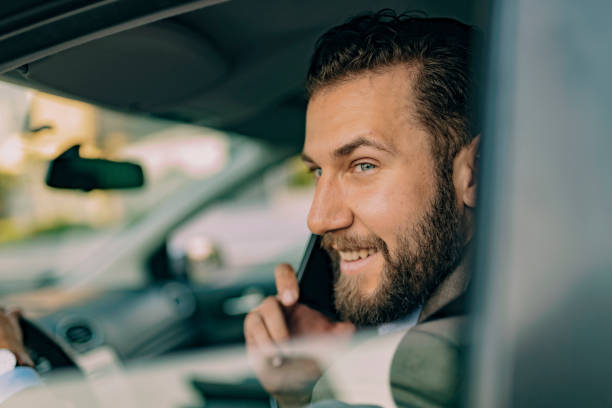 istock Businessman Talking on the Phone while Driving a Car 1161450622