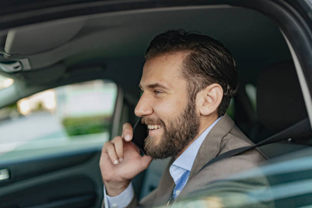 istock Businessman Talking on the Phone while Driving a Car 1161450624