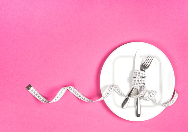 messband weiße platte flachliegen - healthy eating fork tape measure still life stock-fotos und bilder