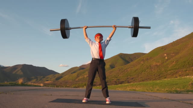 Young Boy Businessman Lifting Weights