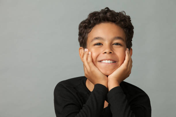 istock Closeup studio portrait of a 12 year old boy on gray background 1161457351