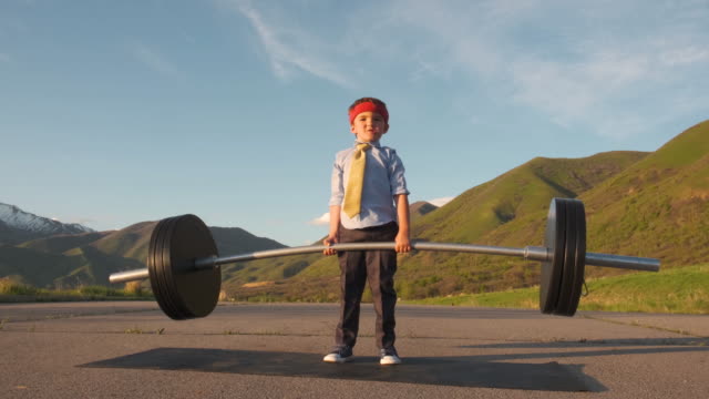 Young Boy Businessman Lifting Weights
