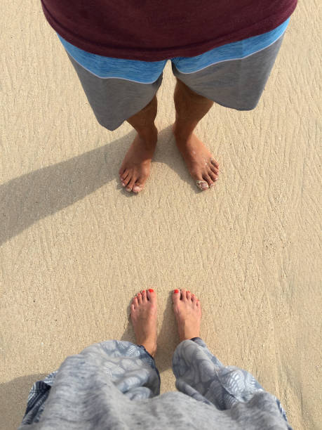 male and female feet standing on a beach - bali male beautiful ethnicity imagens e fotografias de stock