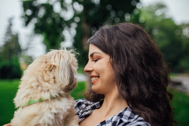 istock Smiling girl holding a dog 1161458271