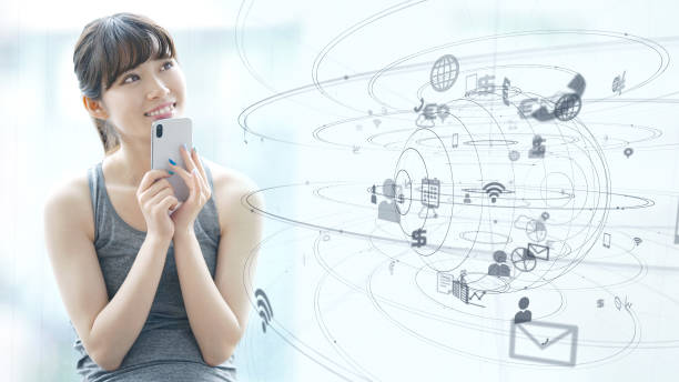 istock IoT (Internet of Things) concept. Asian girl using a smart phone. 1161459574