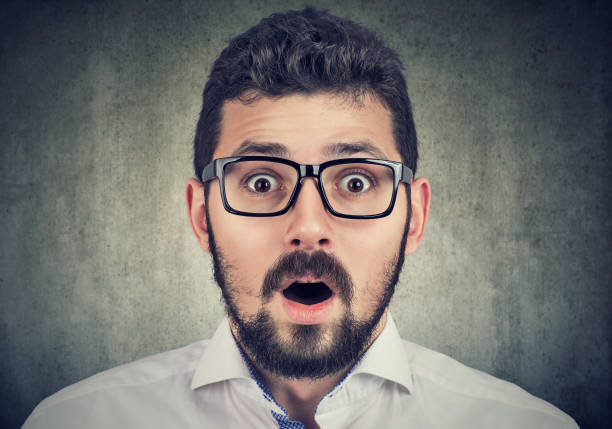 istock Portrait of young man with shocked face expression 1161466332