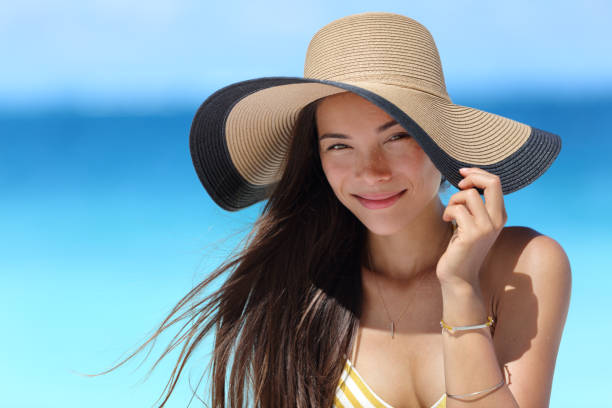 istock Asian woman with beach hat for face sun protection 1161467674