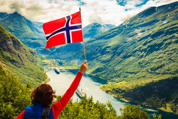 istock Tourist over Geirangerfjord with norwegian flag 1161467677