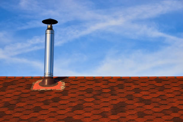 istock Metal chimney on the red roof 1161469439