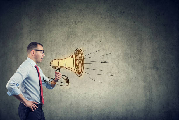 istock businessman screaming into a megaphone 1161469457