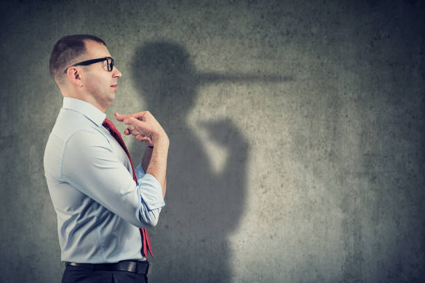 istock Side view of a businessman looking surprised when being caught on lie 1161469987