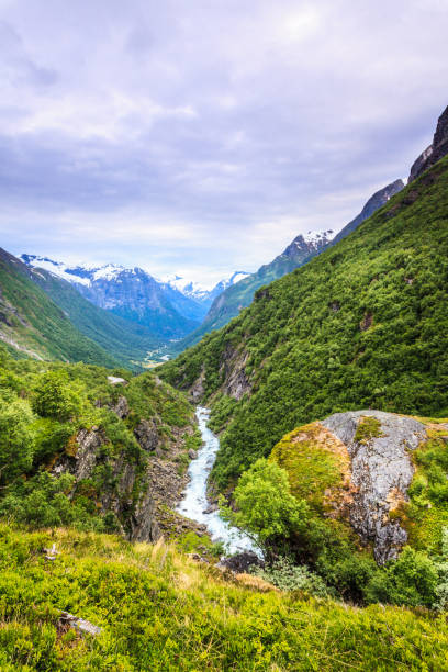 Tourism vacation and travel. Mountains landscape at summer and snowcapped mountain tops in the background, Norway, Scandinavia.