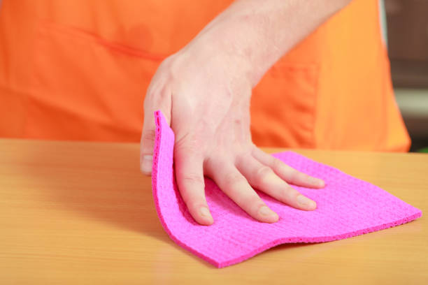 istock male hand cleaning table with rag at home kitchen 1161472669
