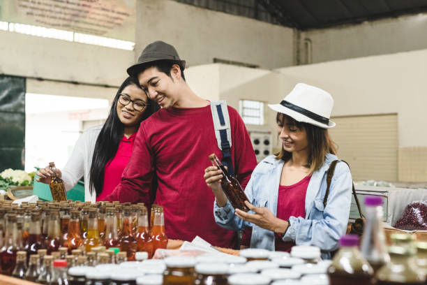 Asian young people buying at the fair Asian young people buying at the fair oriental food stock pictures, royalty-free photos & images