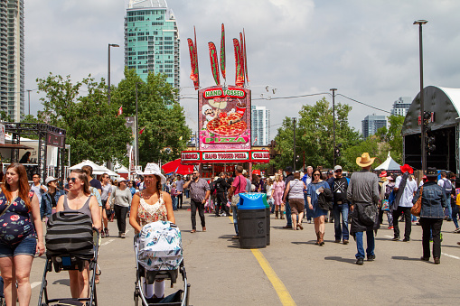 A crowd filled the street on Olympic Way SE at the annual Calgary Stampede event. The Calgary Stampede is often called the greatest outdoor show on Earth.