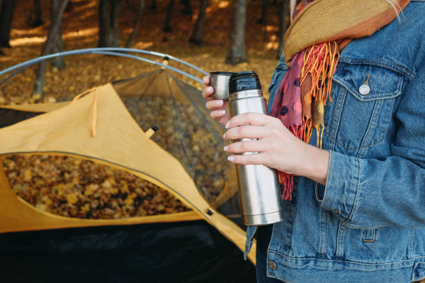 istock fall camping lady vacuum flask autumn nature park 1161476071