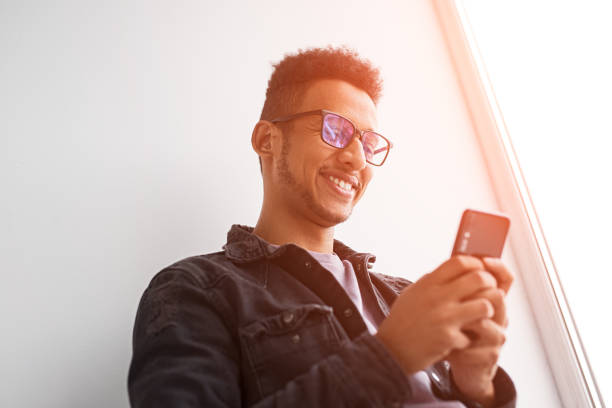 istock Cheerful black male using smartphone in morning 1161476407